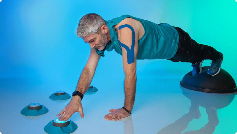 A man doing a plank while tapping out a Pod light