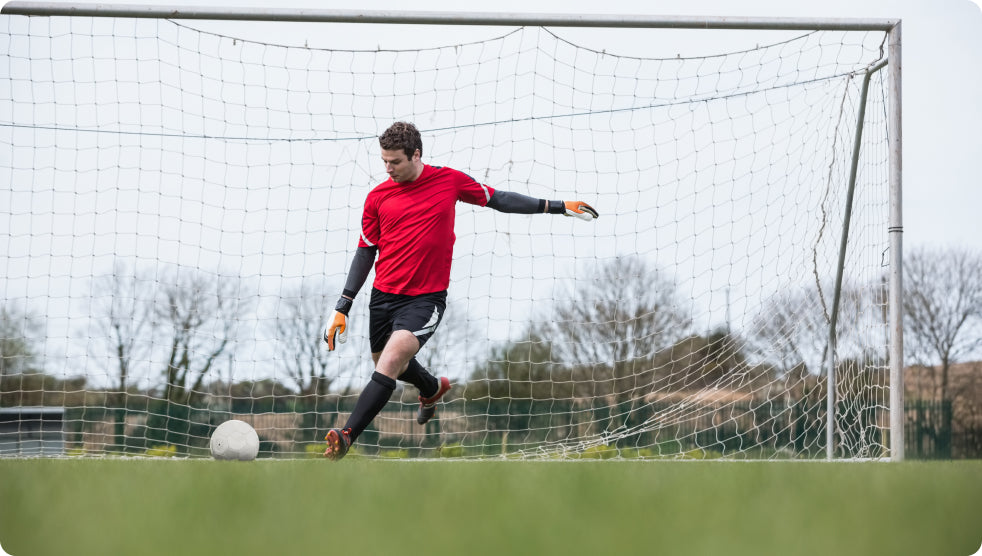 Goalkeeper kicking the ball out from the goal