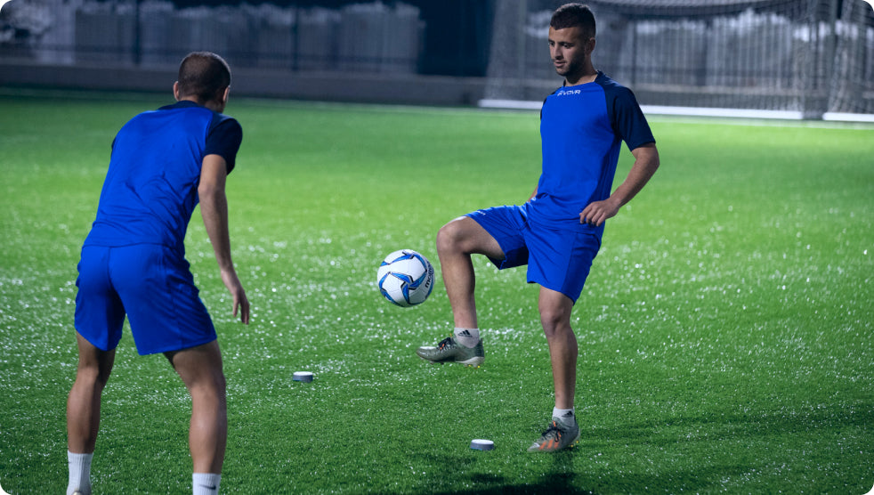 Soccer players kicking around a ball