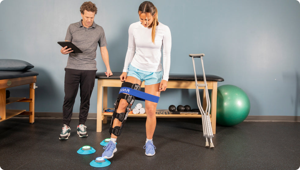 A physical therapist helping a patient recover from an injury