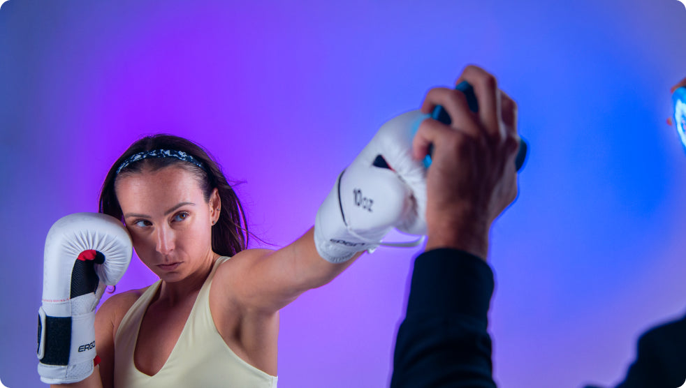 A boxer wearing gloves and practicing her hit