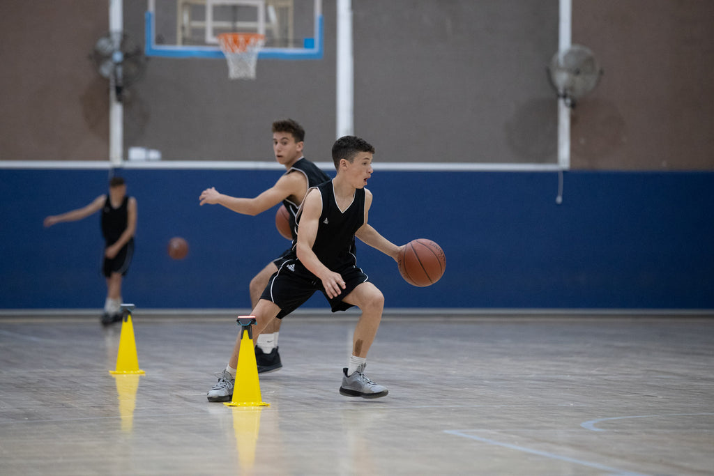 A team of basketballers practising dribbling