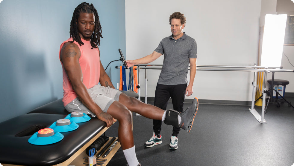 A physical therapist helping a patient by using BlazePod