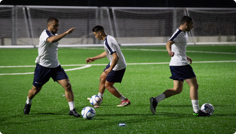 Soccer players practicing their dribbling skills