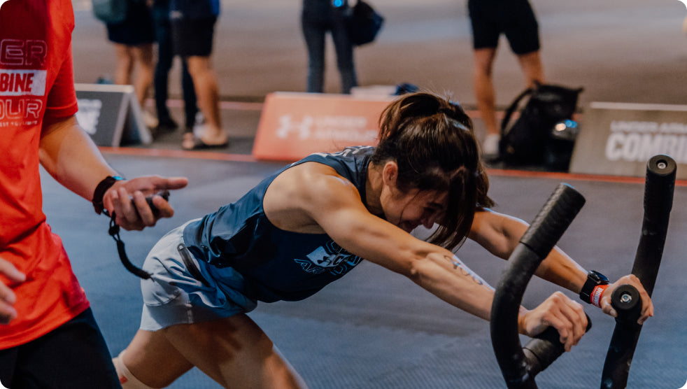 A female athlete pushing a rig to train her whole body