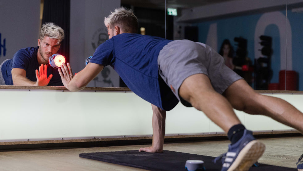 An athlete training with BlazePod in front of a mirror