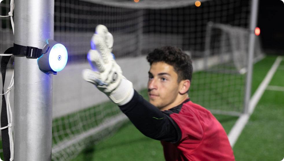 Goalkeeper hitting a BlazePod Pod attached to a goal post