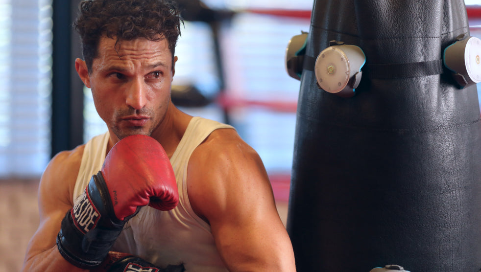 A boxer gearing up to train with a boxing bag