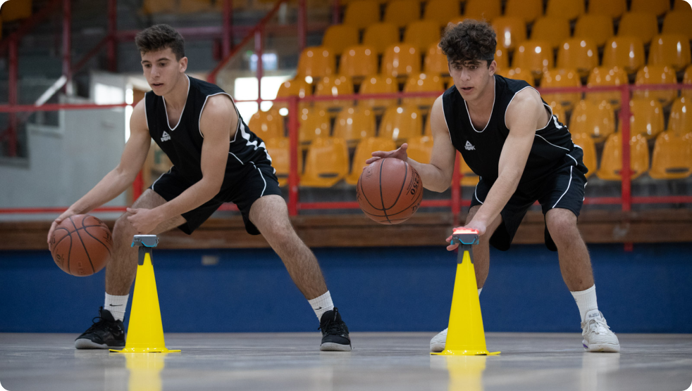 Two basketballers using BlazePod and cones to improve their reaction time