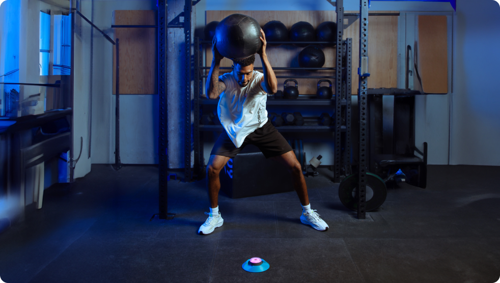 A man smashing down a training ball onto a Pod