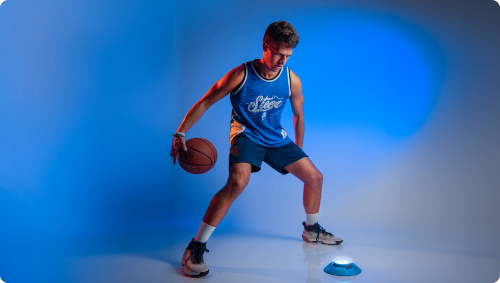 A basketballer in a studio showing off his tricks and skills