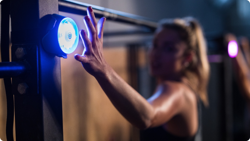 A woman tapping out a Pod in the gym