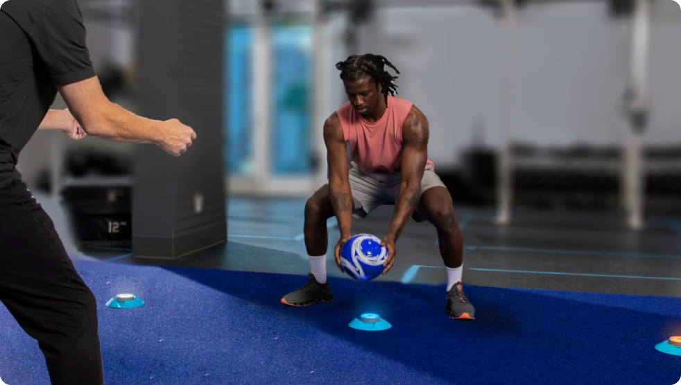 A physical therapist guiding an athlete in a session